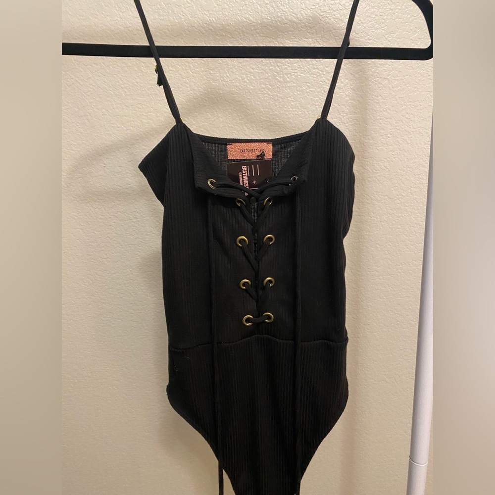 Black bodysuit with tie detail. New never worn. With tags.